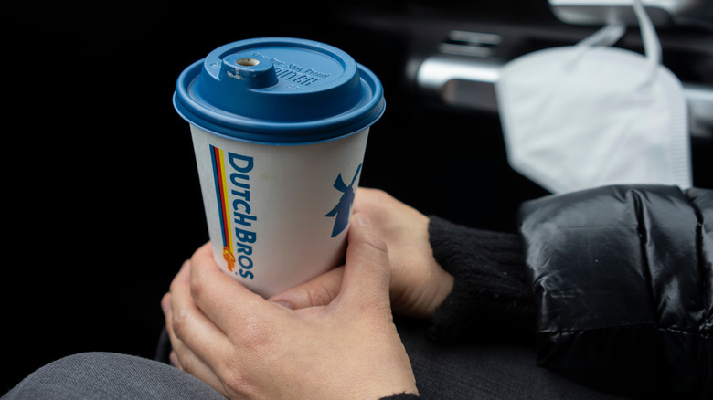 person holding cup of Dutch Bros coffee