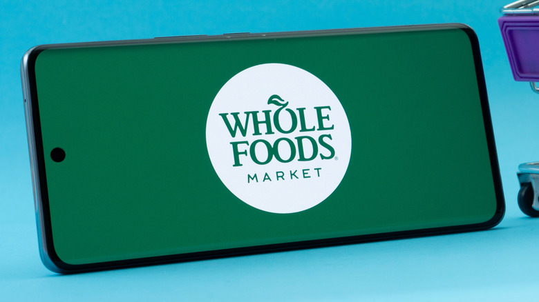 Phone with Whole Foods app on screen
