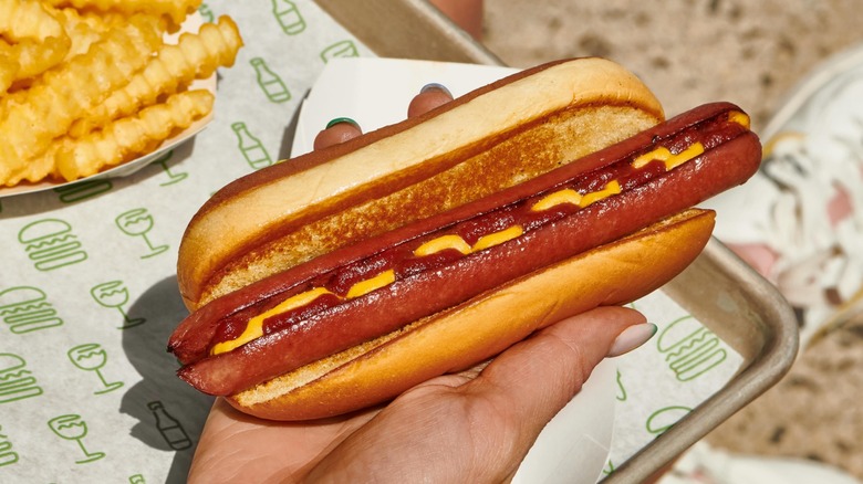 Griddled flat-top hot dog from Shake Shack beside fries