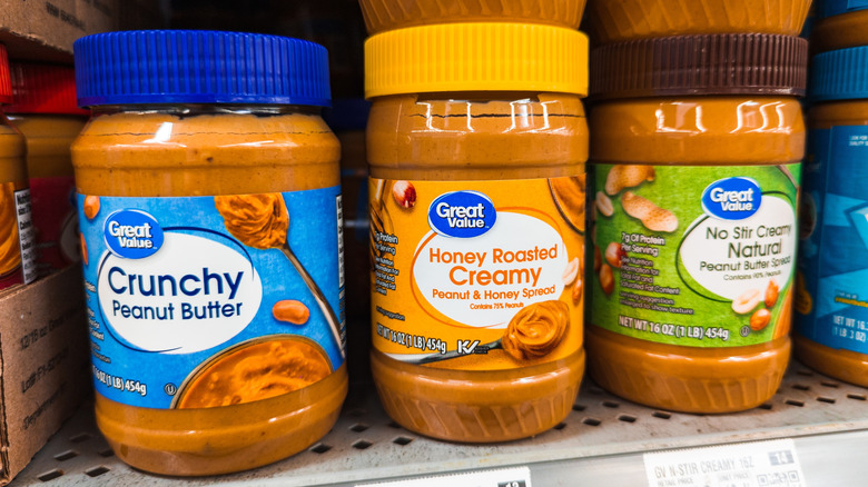 Jars of Great Value peanut butter on the store shelf