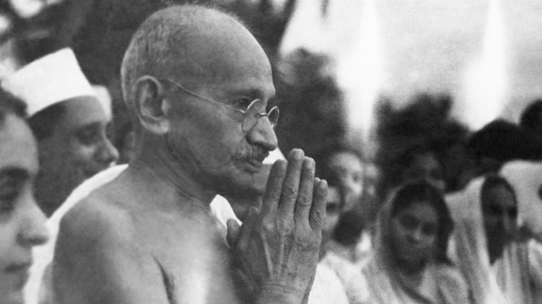 Mahatma Gandhi with his hands folded in front of his face
