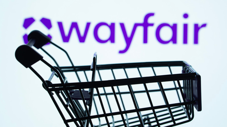 Wayfair logo with shopping cart in the foreground.