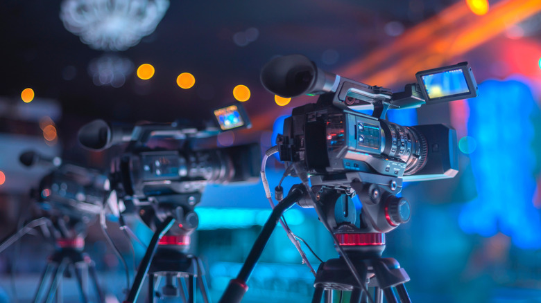 Film cameras shooting an event