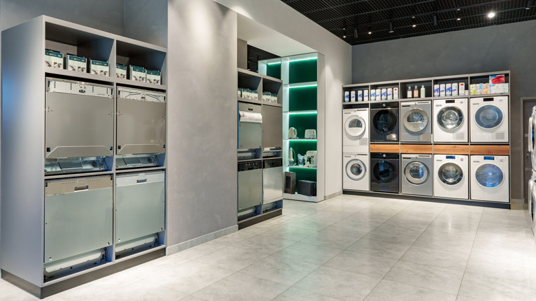 The interior of an appliance store with several dishwashers on display