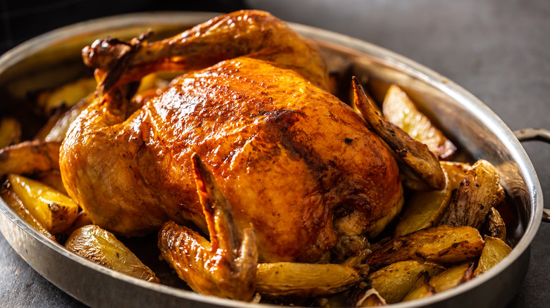 Turkey and potatoes in roasting pan