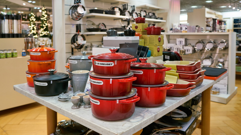 LeCreuset dutch ovens on display at a cookware store.