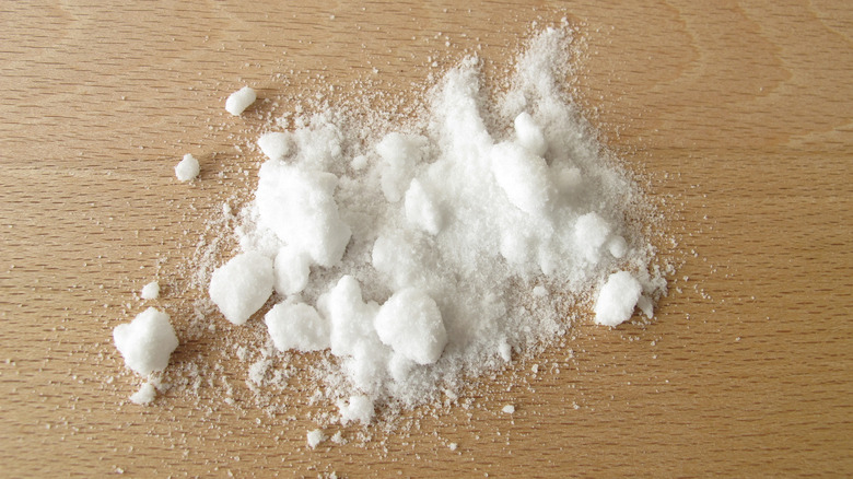 Baker's ammonia in lumps sprinkled on a wooden table