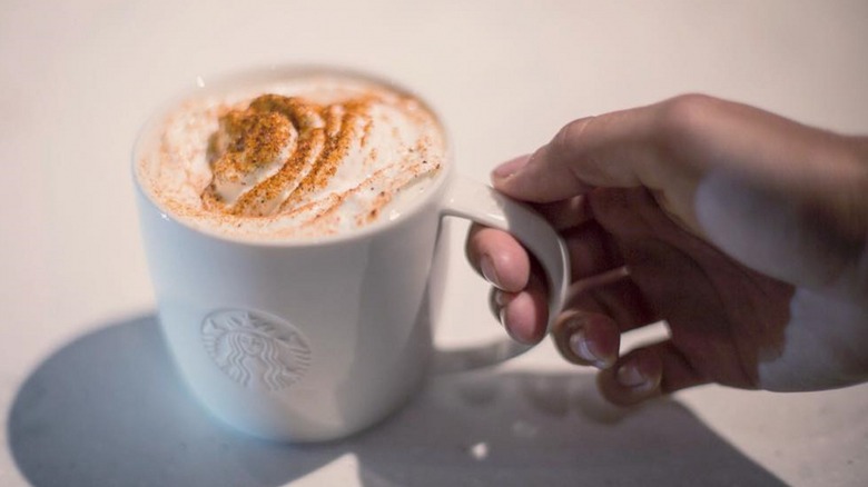 Hand holding a Chile Mocha in a white Starbucks branded mug