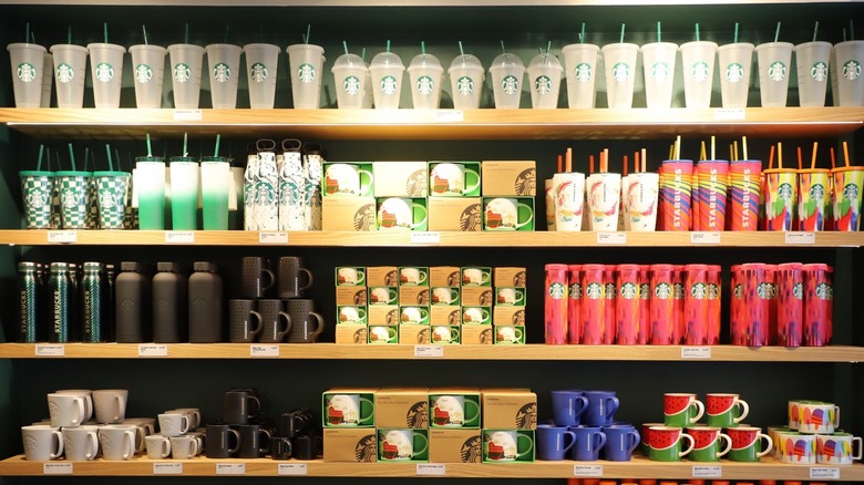 Shelf of reusable Starbucks mugs and cups at a Starbucks store