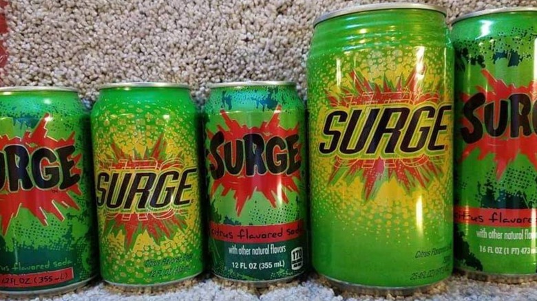 Various Surge soda cans