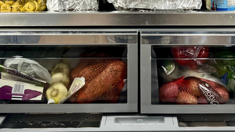 Sweet potatoes in the fridge stored beside garlic bulbs