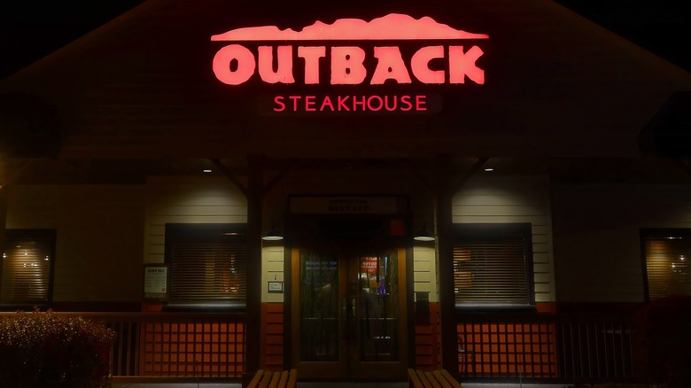 The front of an Outback Steakhouse at night in Peabody, Massachusetts