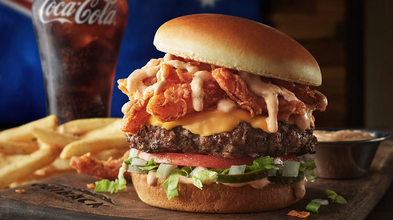 The Bloomin' Burger shown with fries and a coca-cola