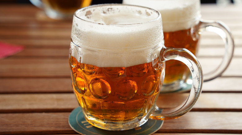 Czech pilsner in a glass mug on a wooden table