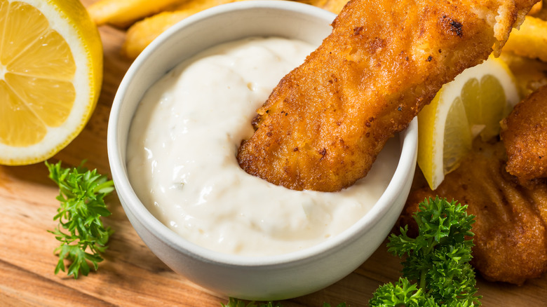 Close-up of a dish of tartar sauce with a fish stick