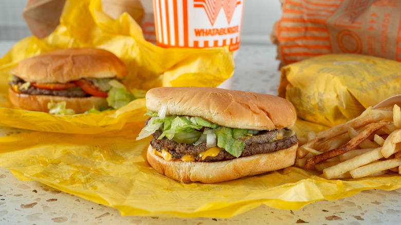 Whataburger cheese burgers with fries and drink