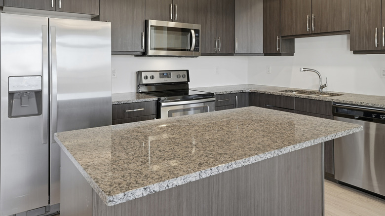 brand new kitchen with a granite countertop