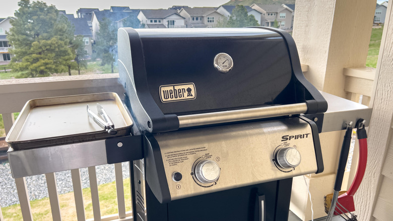 A Weber Spirit gas grill on a porch