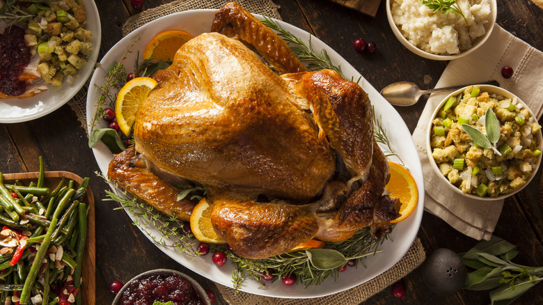roast turkey on table with sides