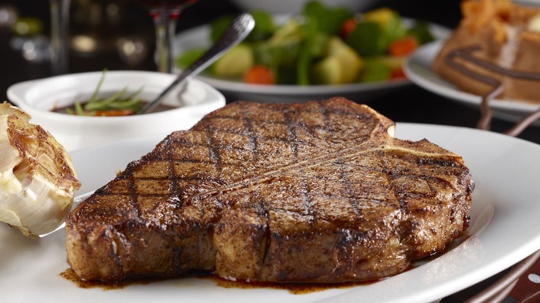 Seared LongHorn Steakhouse porterhouse steak on white plate