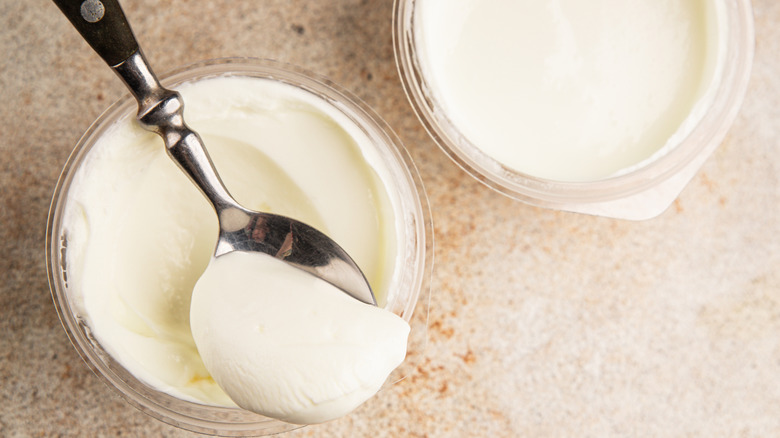 Skyr and yogurt in bowls with a spoonful of skyr