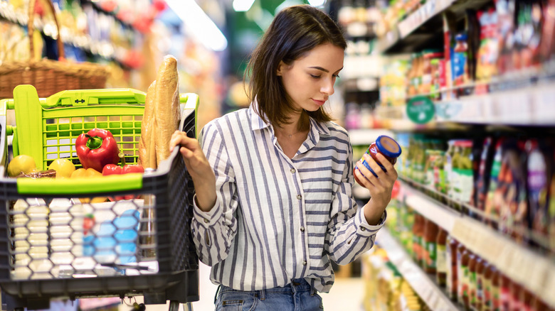 A grocery shopper reading a food label 