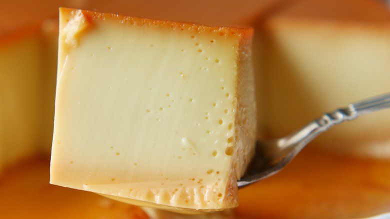 a close up photo of flan resting on a spoon