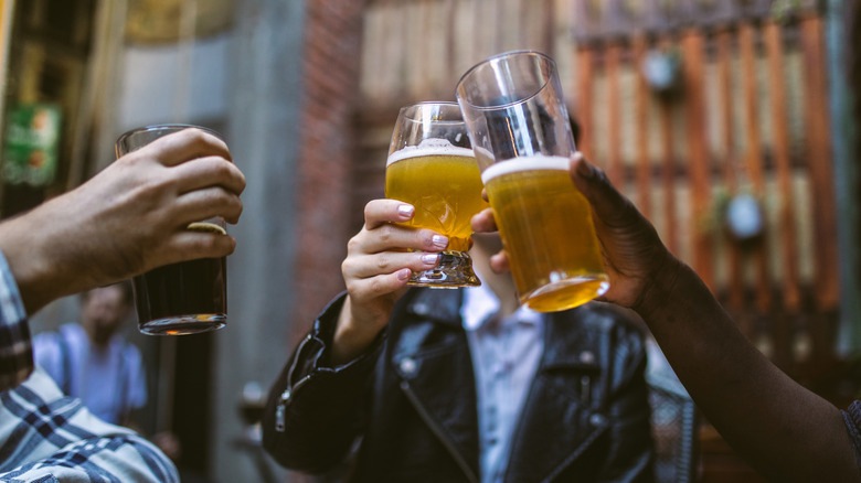 people making a cheers with a few beers