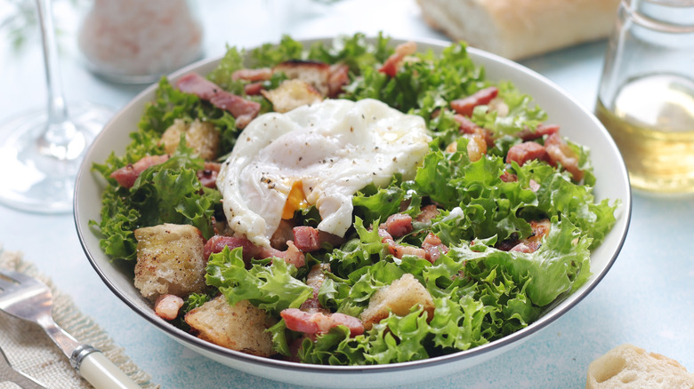 Overhead view of French salad on a set table