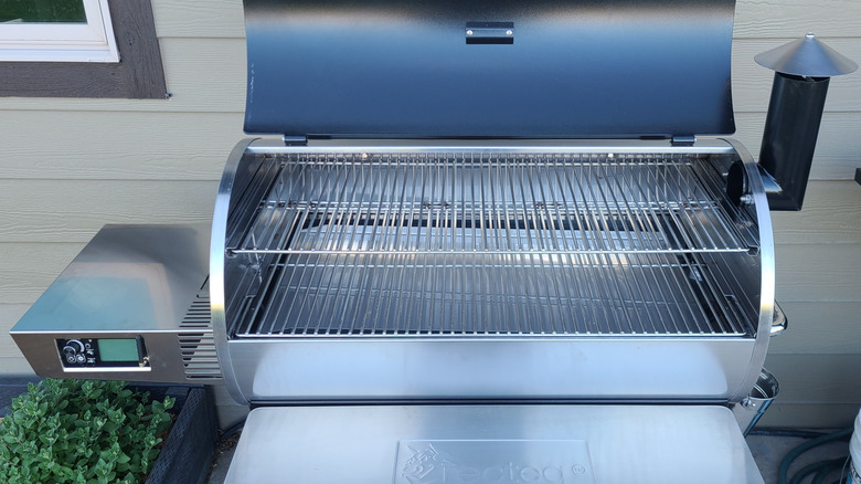 An open pellet grill outside home