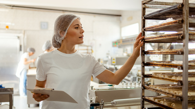 A baker counting and taking stock of pastry items