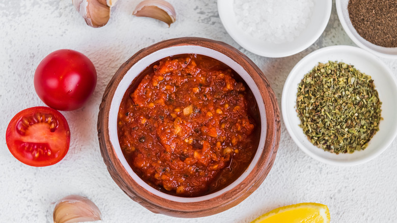 marinara sauce with ingredients including salt and tomatoes in bowls