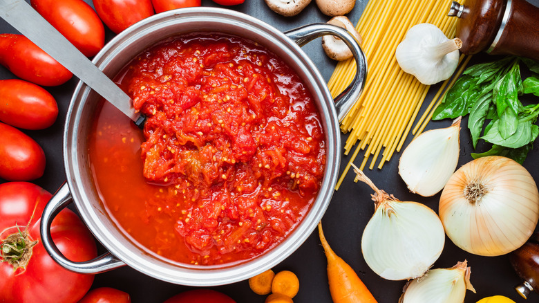 Pot of marinara sauce with varied ingredients