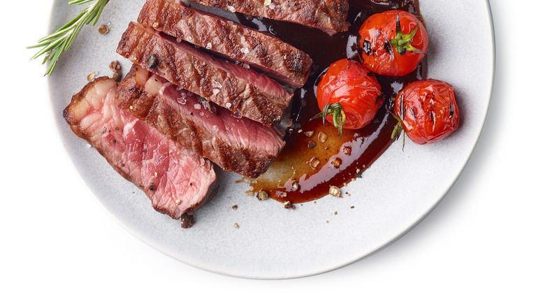 Steak on plate with tomatoes 