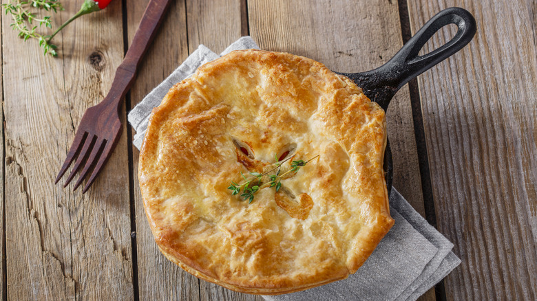 pot pie in cast iron pan with fork