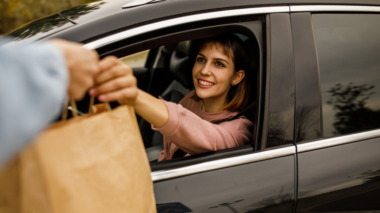 Employee delivering curbside food order