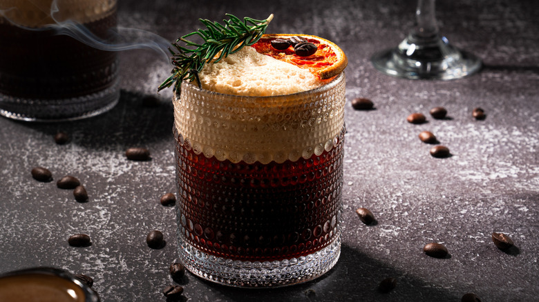 Espresso coffee garnished with rosemary.