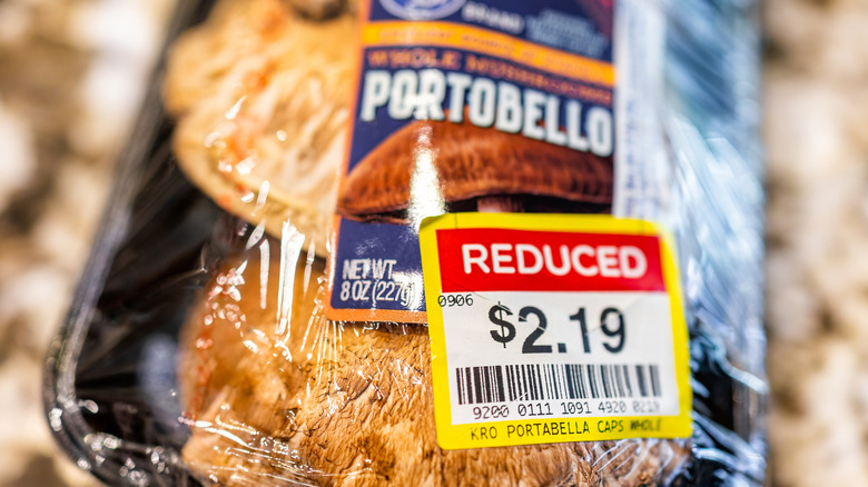 Portobellos with a Kroger "Reduced" sticker, close up