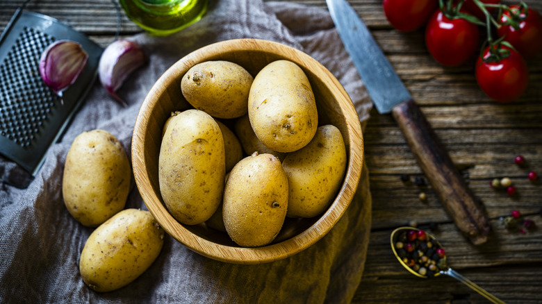 Bowl filled with raw fingerling potatoes shot from above on rustic table