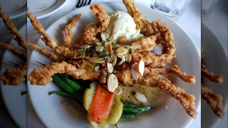 Fried soft shell crab in a white bowl with vegetables