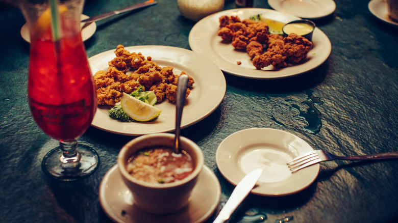 A classic New Orleans-style dinner with a cocktail at a restaurant