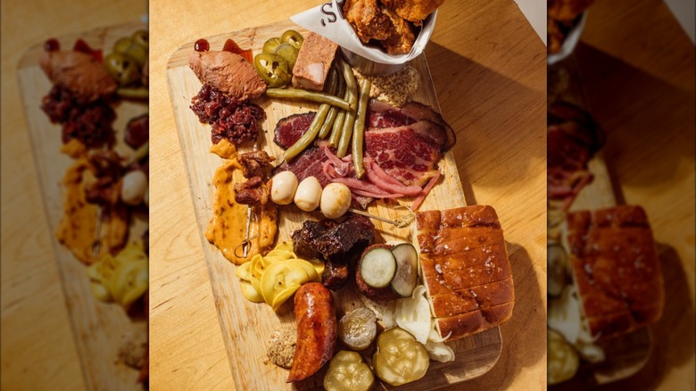 A charcuterie board with Cajun-style meats and pickled veggies