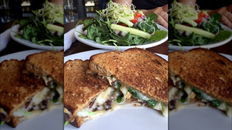 The Perfectly Grilled Cheese on a plate in front of a salad