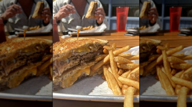 Cowboy burger grilled cheese on a plate with fries