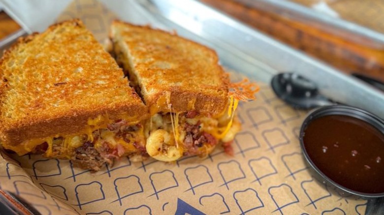Oinker grilled cheese on a tray with sauce