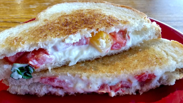 Two halves of a grilled cheese sandwich with bell peppers stacked atop one another