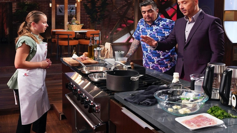 Masterchef Gen X contestant in kitchen while judges look over her work