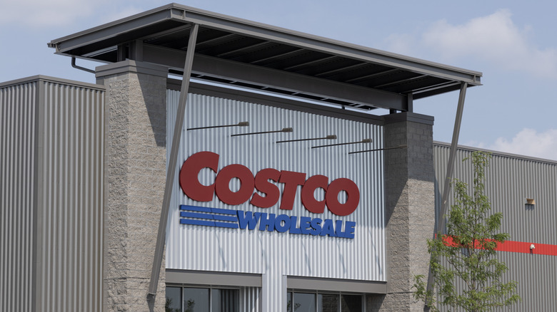 A zoomed in picture of the large sign above a Costco store during the daytime