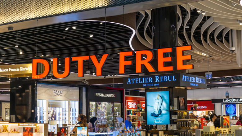 A generic shot of a duty free shore with people inside checking out products