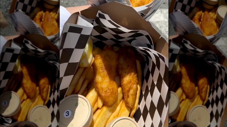 Fish and chips on white and black checkered paper